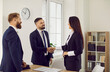 © Studio Romantic - Handshake for new agreement. Business people end meeting by shaking hands with each other as sign of successful partnership. People in formal wear at business meeting in office. Business concept.