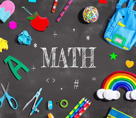 Math theme with school supplies on a chalkboard - flat lay