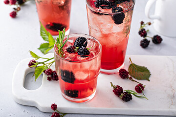 Refreshing blackberry cocktail with fresh sprig of rosemary