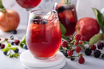 Fall berry and apple sangria in a glass with ice