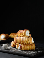 Canvas Print - Baked tubules with whipped protein cream on a wooden board