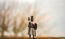 Knight Templar Statuette With Trees On Background. Templar Knight Statue
