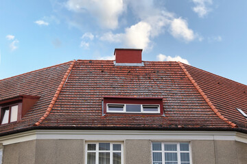 Beautiful house with red roof against blue sky