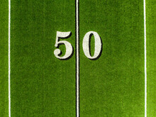 Aerial Image Of A Typical Synthetic Turf Football Field 50 Yard Line In White. 	