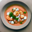 Hot Tomato soup with shrimp. Seafood creamy soup with goat cheese, olive powder, wild shrimps on bowl plate at wooden table, top view, close-up. Delicious vegetarian diet food