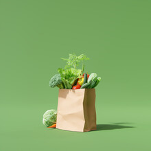 Paper Bag With Fresh Vegetable On Green Background. Food Concept. 3d Rendering