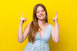 Young caucasian woman isolated on yellow background pointing up a great idea