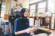 © dodotone - Beautiful young adult asian woman playing a console game at home on days