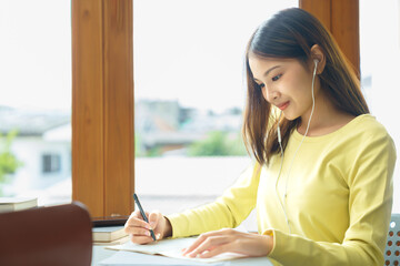 Wall Mural - Education and literacy concept, College student girl use phone to listening lecture and taking note