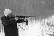 A man with vintage submachine gun in the forest