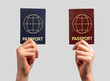 Two different passports in hands. Abstract citizenship nationality documents. Double citizen concept. High quality photo