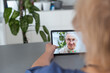 © Angelov - Authentic shot of a happy grandmother is making a video call to relatives with a laptop at home. Concept of technology, modern generation,family, connection, authenticity
