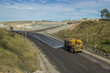 © Austockphoto - Mine truck spraying the roads with water to minimise dust