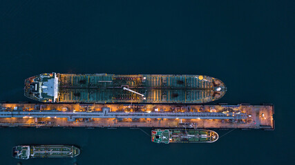 Poster - Aerial view tanker ship vessel unloading at port at night, Global business logistic import export oil and gas petrochemical with tanker ship transportation oil from dock refinery.