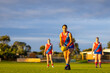 © Austockphoto - female football players in red and blue uniforms at training