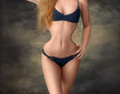 Beautiful woman in bikini with very slim tiny waist