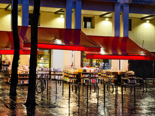 Wall Mural - Bookstore in Paris, France street during evening rain