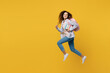 © ViDi Studio - Full body young black teen girl student she wear casual clothes backpack bag jump high look camera run fast hurrying isolated on plain yellow color background. High school university college concept.