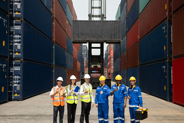 Wall Mural - Portrait group of male and female worker working in container terminal. Attractive business man and woman laborer stand with confidence after process orders at warehouse logistic in cargo freight ship