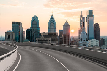 Empty urban asphalt road exterior with city buildings background. New modern highway concrete construction. Concept way to success. Transportation logistic industry fast delivery. Philadelphia. USA.