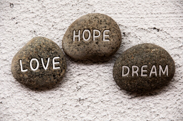 Love, hope and dream engraved on stones. Life concept
