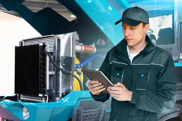 Poster - Serviceman with digital tablet on a background of the tractor with open hood
