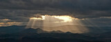 Fototapeta  - Chmury nad górami. Promienie słoneczne.