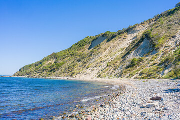 High cliff and rocky shore of the Baltic Sea on the German island of Hiddensee.