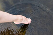 Woman feet slow life and relax on river bark with sunset