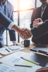 Business people shake hand to confirm the agreement in the business of mutual investment and agree on a unified work contract.