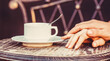 Couple enjoying coffe. Female and man hands holding cup of coffee. Couple in love holding hands with coffee. Lovely couple holding cup of coffe in hands