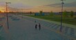 black man is training in park area of city in sunset time, aerial view on two sportsmen, 4K, Prores