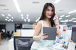 © Montri - Successful businesswoman in Modern office. Confident woman wearing casual clothes. Portrait of young smiling asian woman. Happy girl in creative office. Happy asian Businesswoman Using Computer.