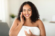© Prostock-studio - Happy black overweight lady using moisturising face cream, holding jar with beauty product and smiling