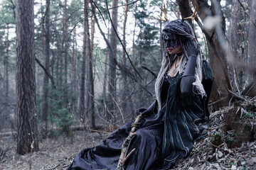 Forest witch in a pine forest