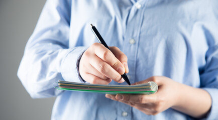 Poster - female hand writing on an blank notebook