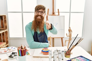 Sticker - Redhead man with long beard painting clay bowl at art studio smiling friendly offering handshake as greeting and welcoming. successful business.