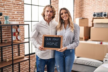 Canvas Print - Young couple moving to a new home smiling with a happy and cool smile on face. showing teeth.