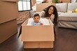 © Krakenimages.com - Mother and son playing with cardboard as a car at new home