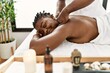 © Krakenimages.com - African american woman reciving back massage at the clinic.