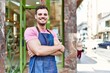 © Krakenimages.com - Young hispanic waiter wearing apron standing with arms crossed gesture at coffee shop.