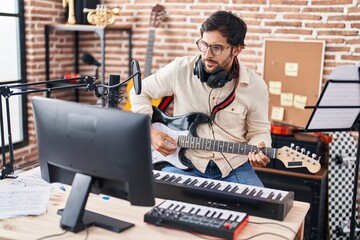 Sticker - Young hispanic man musician playing electrical guitar at music studio