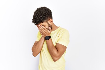 Sticker - Arab young man standing over isolated background with sad expression covering face with hands while crying. depression concept.