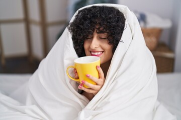 Sticker - Young middle east woman drinking cup of coffee sitting on bed at bedroom