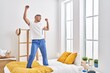 © Krakenimages.com - Young hispanic man dancing on bed at bedroom