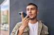 © Krakenimages.com - Young hispanic man smiling confident talking on the smartphone at street