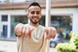 © Krakenimages.com - Young hispanic man smiling confident pointing with fingers at street