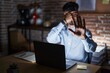 © Krakenimages.com - Young hispanic man with beard working at the office at night covering eyes with hands and doing stop gesture with sad and fear expression. embarrassed and negative concept.