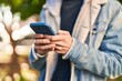 © Krakenimages.com - Young hispanic man using smartphone at park