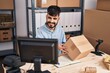 © Krakenimages.com - Young hispanic man ecommerce business worker scanning package at office